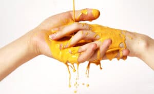 Two hands with yellow paint