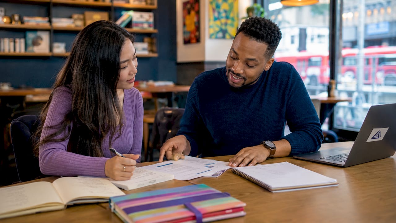 Two educators reviewing TEFL materials
